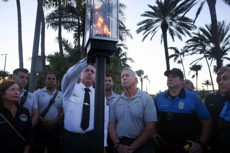 Earlier this month, Miami Dade Fire Rescue Deputy Fire Chief of Emergency Operations Ray Jadallah extinguishes the symbolic flame during a ceremony with other firefighters and community members in front of where Champlain Towers South stood. Wednesday, July 27, 2022, marked one year since the last of the 98 victims of the collapse was recovered.