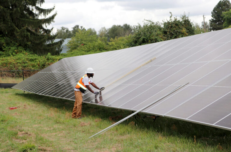 A worker puts the finishing touches on a solar panel in Portland, Oregon.