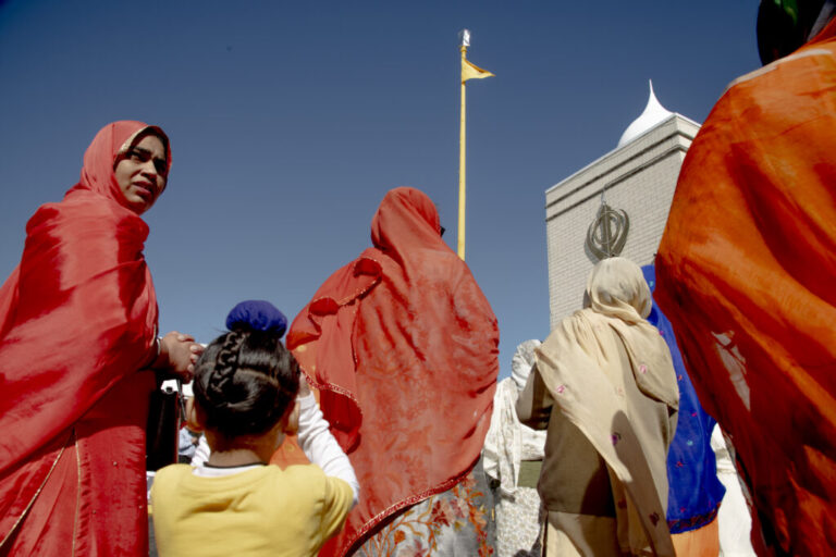 During Vaisakhi, members of the Sikh community ceremonially wash the pole bearing the Nishan Sahib, the Sikh religious flag, and replace its cloth with a fresh or cleaned one. This act symbolizes renewal, purity, and devotion. For children and women, participating in or witnessing the ritual reinforces a sense of belonging, faith, and continuity, passing cultural and spiritual values to the next generation while celebrating the unity and resilience of the community.