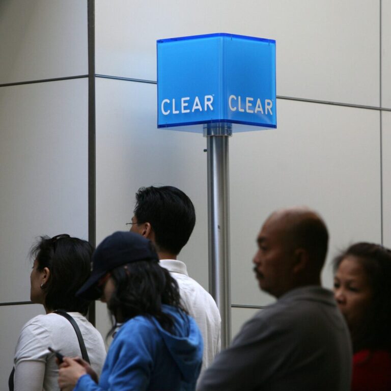 Airline passengers line up near a CLEAR kiosk at San Francisco International Airport.