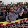 Supporters of ousted Peruvian President Pedro Castillo march at the Plaza San Martin in Lima, Peru on Thursday. Peru's Congress voted to remove Castillo from office Wednesday and replace him with the vice president, Dina Boluarte, shortly after Castillo tried to dissolve the legislature ahead of a scheduled vote to remove him.