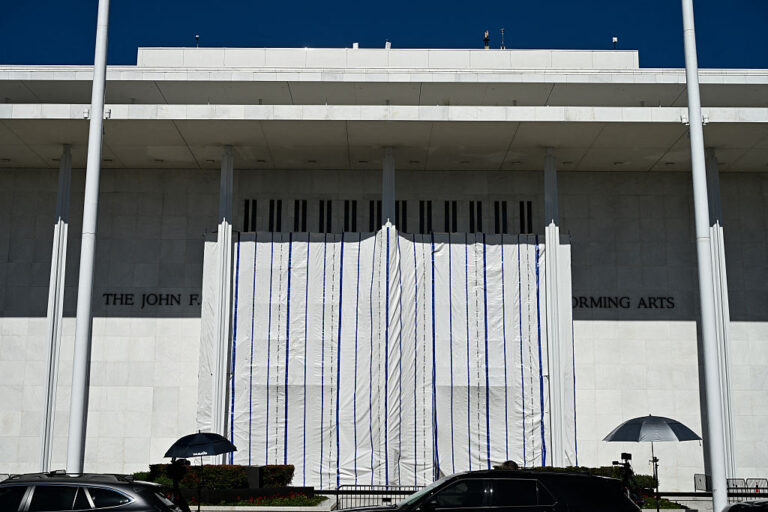 A tarp covers the facade of the John F. Kennedy Memorial Center for the Performing Arts in Washington, DC, on June 13, 2026. Workers removed President Donald Trump's name from the facade of the building.