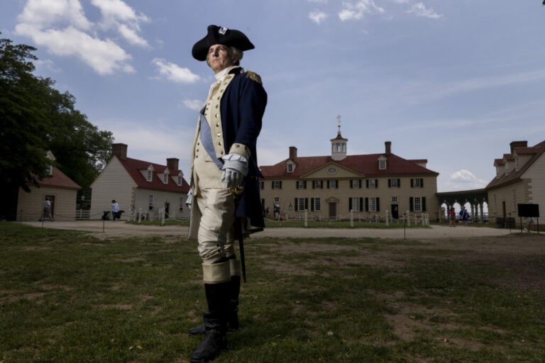 Doug Thomas, a first person interpreter, poses for a portraits as General George Washington in front of the Mount Vernon mansion in Virginia.