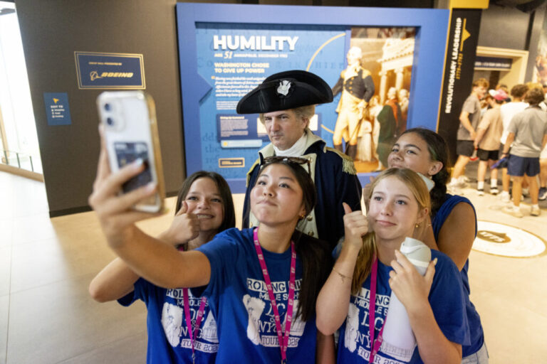 At the opening of the “George Washington: A Revolutionary Life” Exhibition at the Mount Vernon education center, first person interpreter, Doug Thomas, takes a portrait with visitors as General George Washington. The students were from Rolling Hills Middle School in Rolling Hills, Calif.