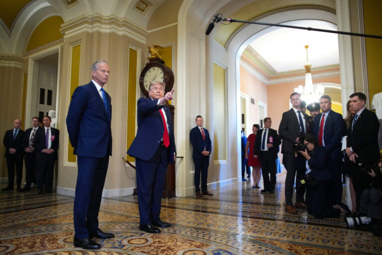 Senate Majority Leader John Thune, R-S.D., watches as President Trump speaks to the media as they arrive at the Capitol on Wednesday.