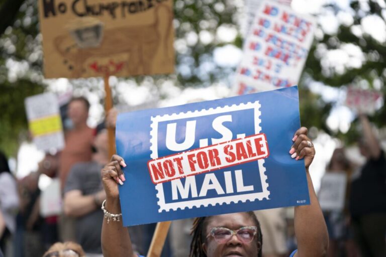 A demonstrator holds a sign that says “U.S. MAIL NOT FOR SALE” during an April protest in Columbia, S.C.