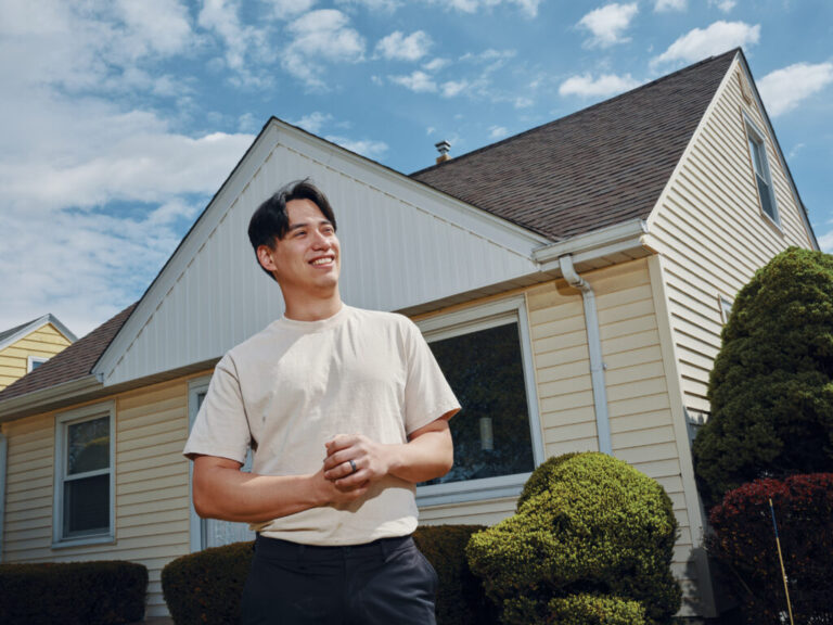 Francisco Vazquez, 27, stands in front of his new home in Milwaukee, Wis. He was able to buy it after changing his career track and saving aggressively, including for one year while he lived rent free with his parents.
