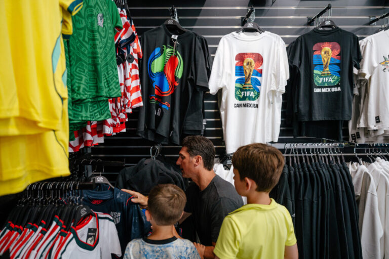 Rochester Hills, MI - June 10, 2026: While on a shopping trip, Matt Abro, 39, looks at football jersey sizees for his sons at Soccer World in Rochester Hills, MI. (Photo by Nick Hagen for NPR)