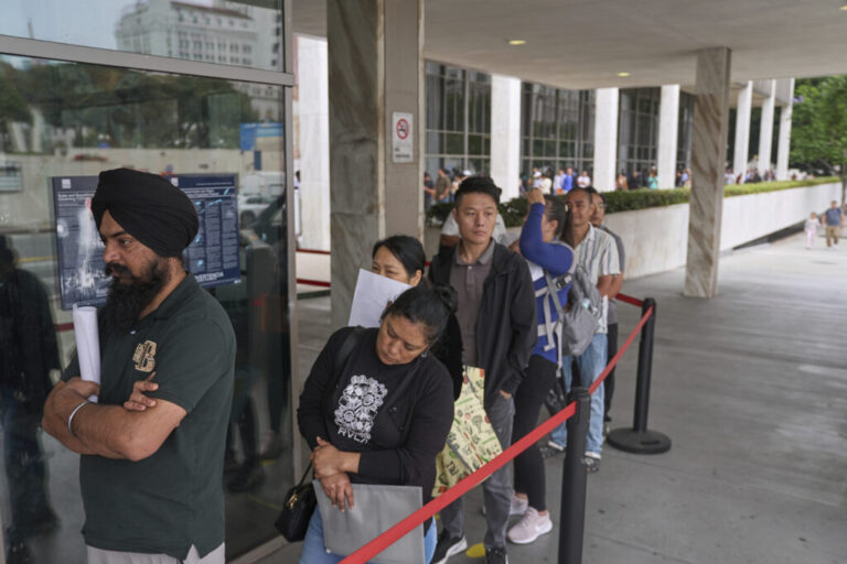 In June 2025, people stand in a long line outside the Los Angeles Federal Building.
