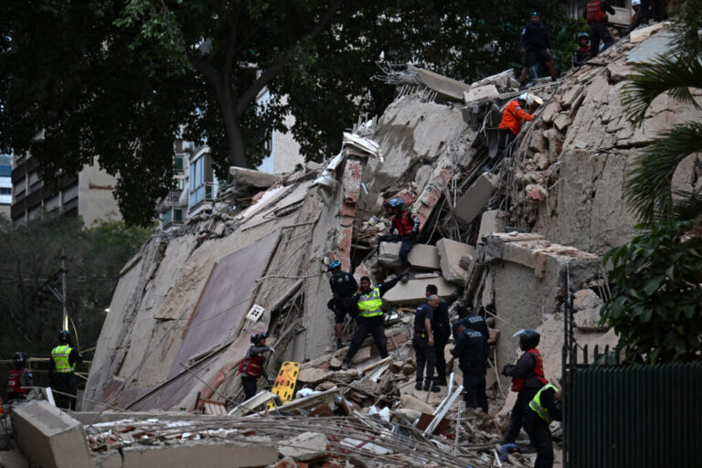 Rescuers search for victims in a collapsed building following an earthquake in Caracas on June 24, 2026.