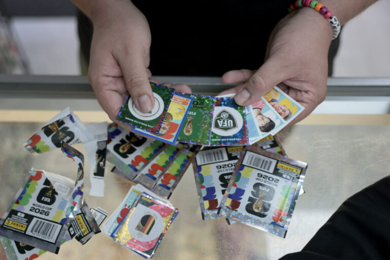 A sticker enthusiast shows off some of the FIFA World Cup 2026 Panini stickers bought at the Soccer Locker on June 2 in Miami.
