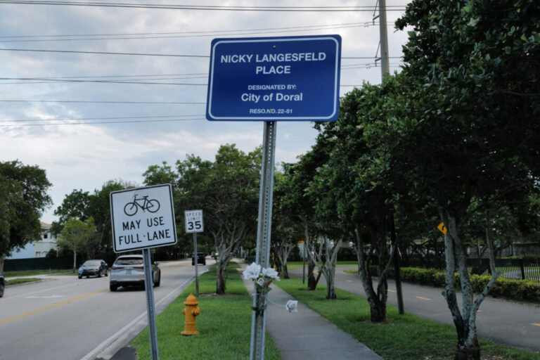 Flowers are wrapped around a sign honoring Nicky Langesfeld, who was killed along with her husband, Luis Sadovnic, in the 2021 Champlain Towers South collapse, Monday, April 27, 2026, in Doral, Florida. The city designated the street