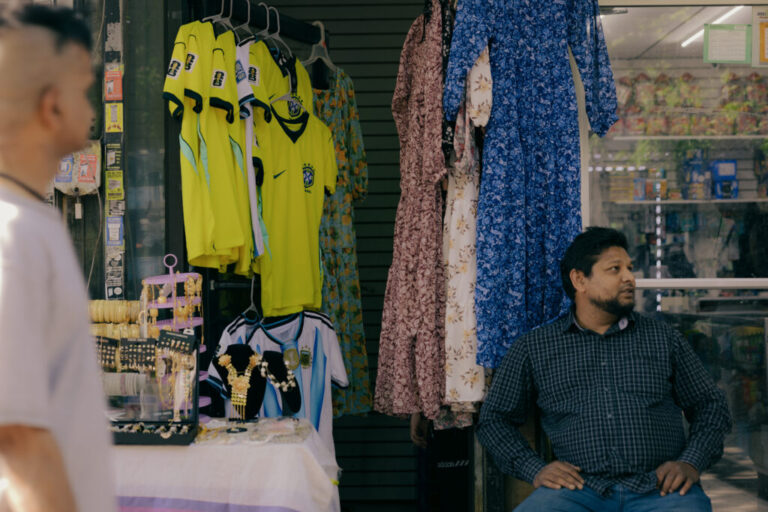 As commotion fills the air of Diversity Plaza, MD Islam displays popular jerseys within the community for potential customers in Queens, New York, U.S., on Sunday, June 7, 2026. CREDIT: José A. Alvarado Jr. for NPR, @josealvarado