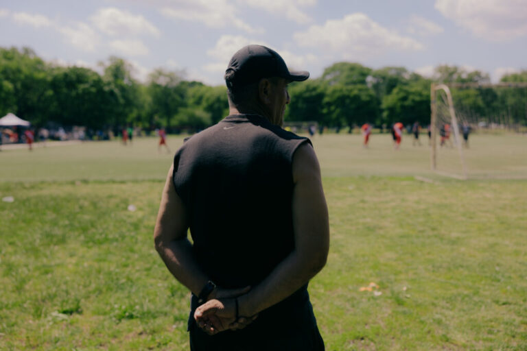 Guillermo Andrade, Head Coach of the Peruvian American Soccer, stands for a portrait as his team play against Galaxy FC on field 5 in Flushing Meadows Corona Park as commotion from echoes off the multiple fields hosting adult recreational league soccer matches in Queens, New York, U.S., on Sunday, June 7, 2026. CREDIT: José A. Alvarado Jr. for NPR, @josealvarado