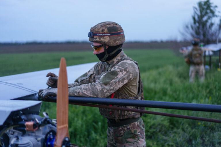 Soldiers form the First Center of Unmanned Systems preparing long/middle strike drones for launch in undisclosed location in Ukraine on May 21, 2025
