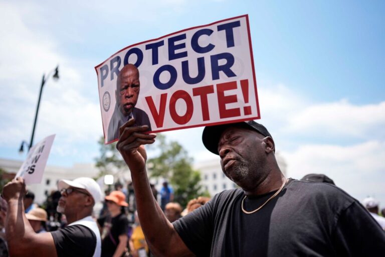 A demonstrator holds a sign saying “PROTECT OUR VOTE!” at a May 16 rally in Montgomery, Ala., responding to the recent U.S. Supreme Court ruling that weakens Voting Rights Act protections against racial discrimination in redistricting.