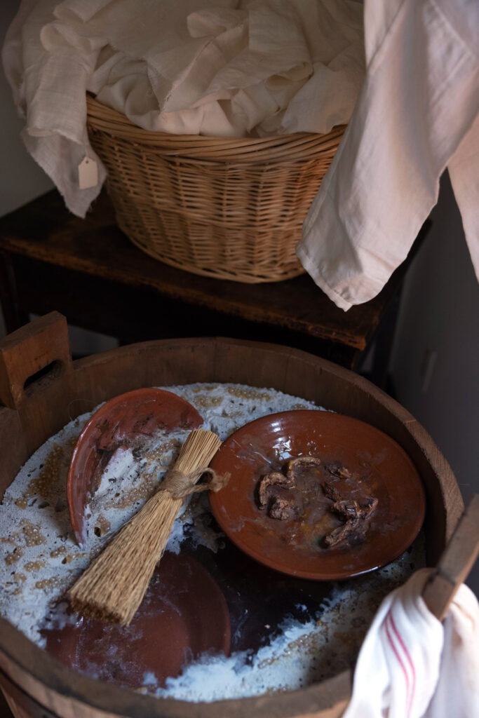 A replica of dirty dishes being washed is seen in the quarters and kitchen used by enslaved people to prepare food at the Paca House.
