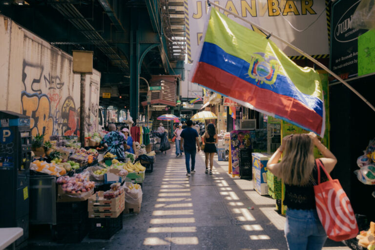 Residents navigate the bustling Roosevelt Avenue in Queens, New York, U.S., on Sunday, June 7, 2026. CREDIT: José A. Alvarado Jr. for NPR, @josealvarado