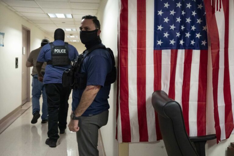 Federal agents stand outside an immigration court at the Jacob K. Javits federal building in New York in September 2025.