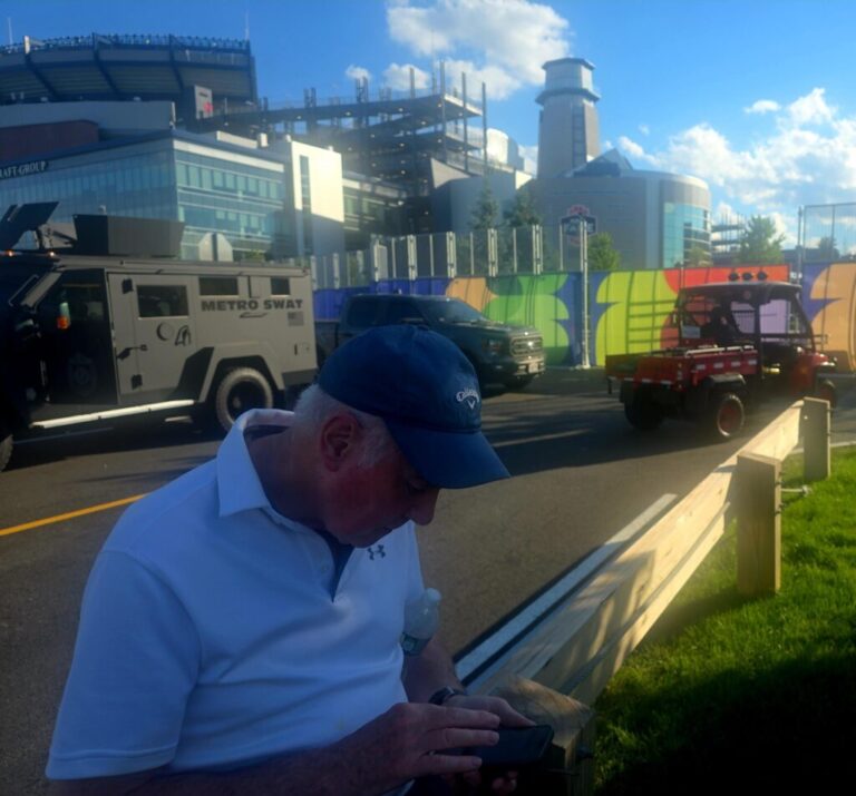David Wain, a friend of John McNicholas' who was visiting from England, sits outside Gillette Stadium, known as Boston Stadium during the World Cup, after the pair's game tickets never arrived.