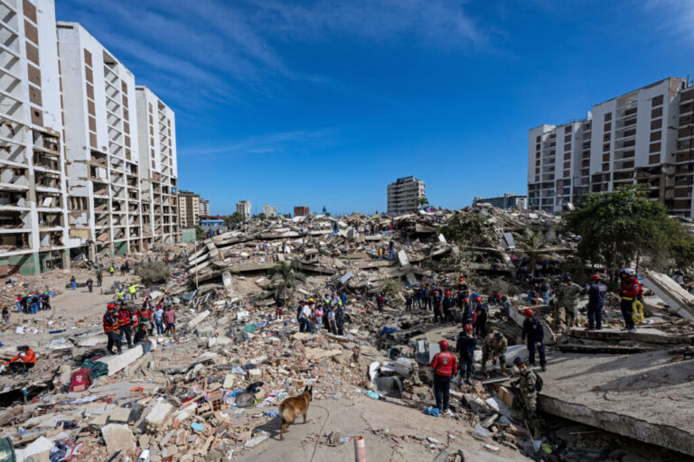 A rescue dog from the Argentine search and rescue team searches for bodies in the rubble of a collapsed building in Caraballeda, La Guaira state, Venezuela, on June 28, following twin earthquakes on June 24. Thousands of rescuers, relatives and volunteers dig day and night through mounds of concrete to find people.
