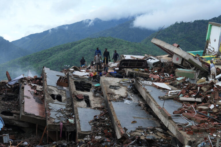 Residents on Tuesday search through the rubble of a building that collapsed in the June 24 earthquakes in La Guaira, Venezuela.