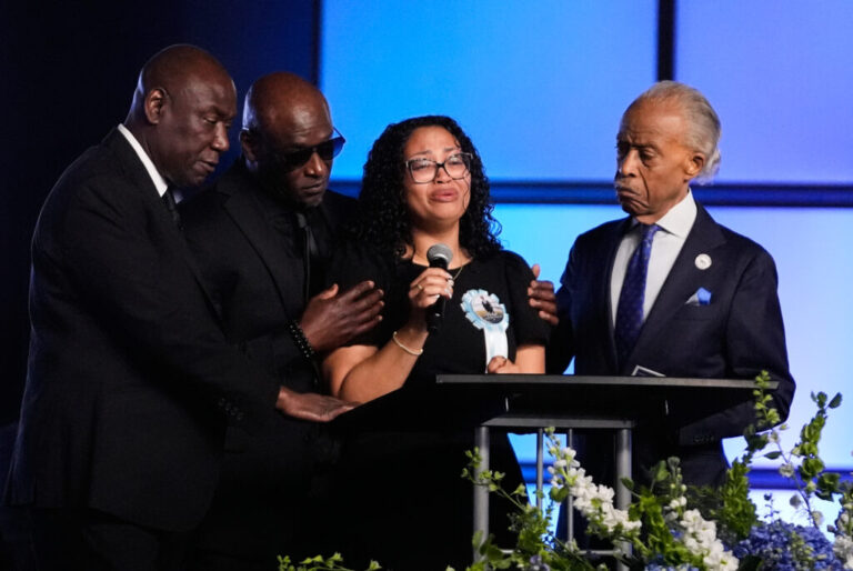 Christine Wells-Wonsley (center) is flanked by her husband, Elmore (second from left), attorney Ben Crump (left), and the Rev, Al Sharpton (right) during a memorial service on Monday in Ocean Springs, Miss., for her son Nolan Xavier Wells, an 18-year-old found dead after taking a July 4 boat trip with friends.