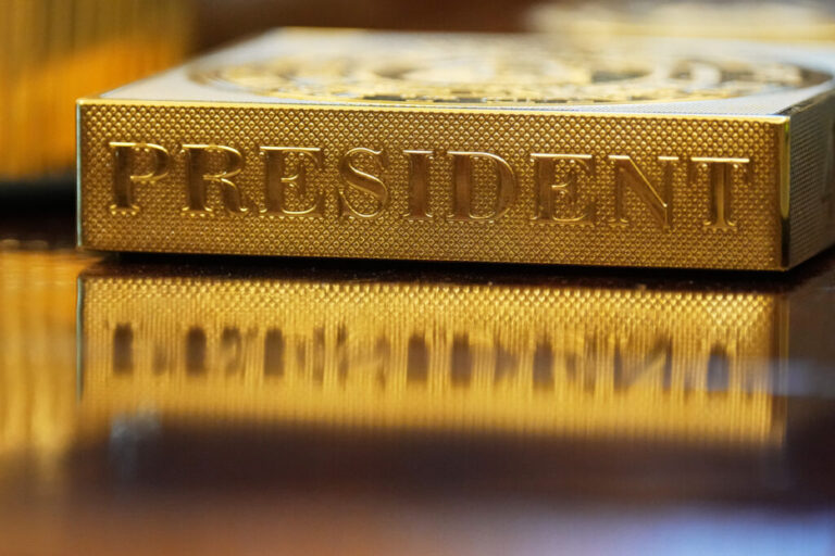 A gold-colored item embossed with the word