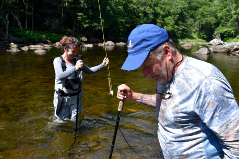 Noreen Finnegan (left) and Jim Faust (right) fly fish in the Deerfield River in Massachusetts on June 27, 2026.