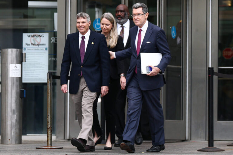 Former U.S. Olympian David Hearn (left) walks with his attorney Norman Eisen to speak to reporters and protesters gathered after his arraignment at the Superior Court of the District of Columbia in Washington, D.C. on Thursday.