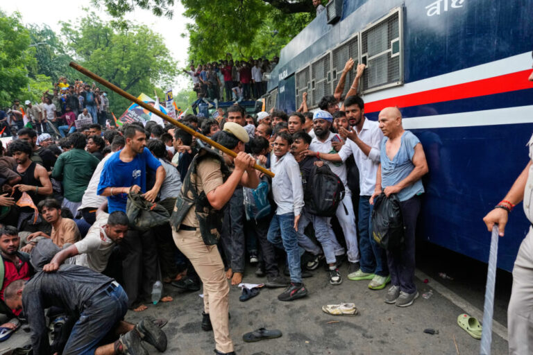 Police use batons to disperse supporters of the Cockroach Janta Party as they attempt to march toward India's Parliament, demanding the resignation of the education minister, in New Delhi, India, Monday, July 20, 2026.