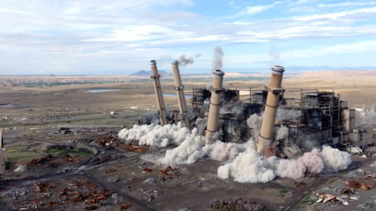 Smokestacks at the San Juan Generating station in New Mexico fall in an explosive demolition on Aug. 24.