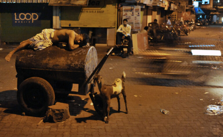 Hot overnight temperatures wreck people's sleep all over the world. In India, many people like this worker sleep outside to seek respite from searing temperatures. Climate change is making nights hotter, causing more sleep loss, according to a new study.