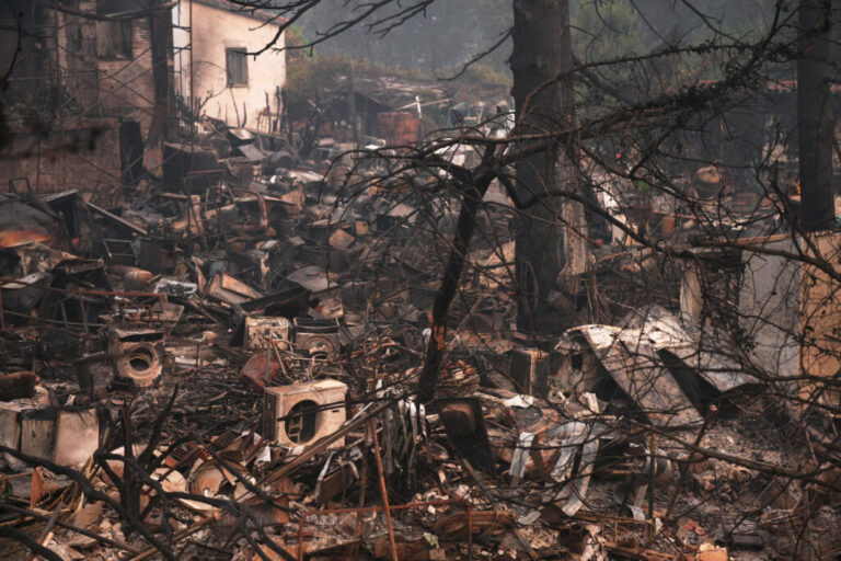 A house and belongings destroyed by a wildfire are photographed as the fire continues to spread near Pelayos de la Presa, Madrid province, Spain, Tuesday, July 28, 2026.