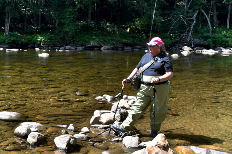 Amy Delaney poses for a photo while fly-fishing along the Deerfield River in Charlemont, Mass. on June 27, 2026.