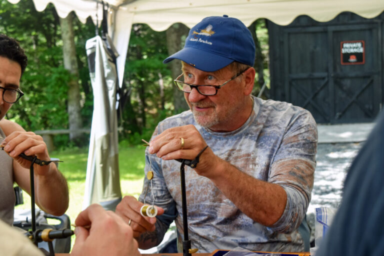 Jim Faust teaches ____ how to fly fish near the Deerfield River in Massachusetts on June 27, 2026.