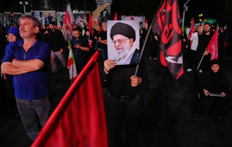 A man holds a poster of the late Iranian Supreme Leader Ayatollah Ali Khamenei in a gathering commemorating him at a square in Tehran on Saturday.