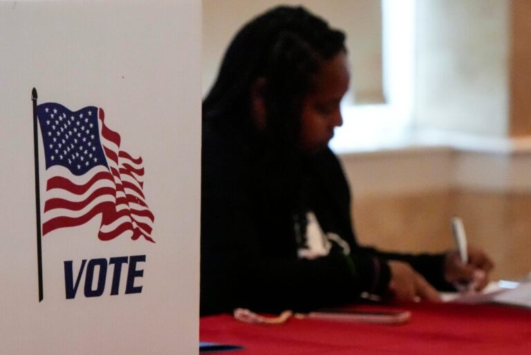A Fulton County staff member works as people vote in a runoff election, TJune 16, 2026 in Atlanta.