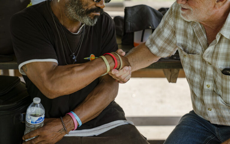 John Lozier, left, sits with Joseph Williams, a chronically homeless man, in Nashville.