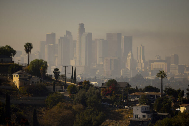 A layer of smog lingers above the downtown Los Angeles skyline in 2024. Millions of Americans are still breathing in unhealthy air, despite long-term progress toward cleaning up many sources of pollution over the years, according to the 2025 State of the Air report.