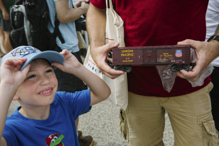 Joe Stefankiewicz, 37, of Aston, Pennsylvania, holds a signed model train car for his son, Joey, 5, in front of Union Pacific’s Big Boy No. 4014, the world’s largest operating steam engine locomotive, during a stop in Philadelphia.