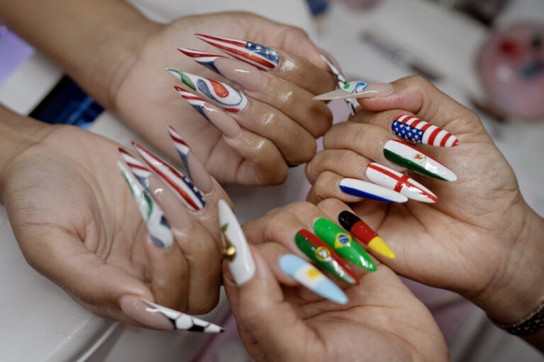 CeeCee Barrett, left, and Vina Nails owner Vy Nguyen, right, showcase their FIFA World Cup-inspired art at her salon in Houston, Texas, on June 26, 2026.