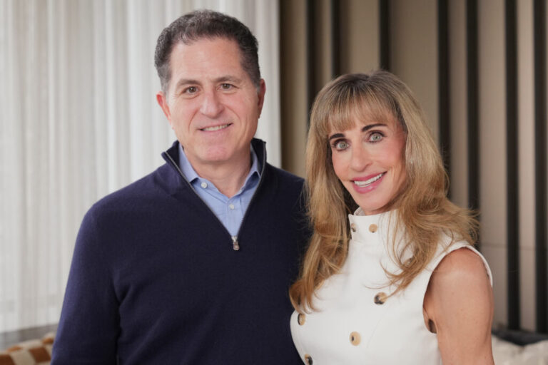 Michael and Susan Dell pose for photographs on Nov. 26 in New York. The couple said they will donate $6.25 billion to fund investment accounts for 25 million U.S. children.