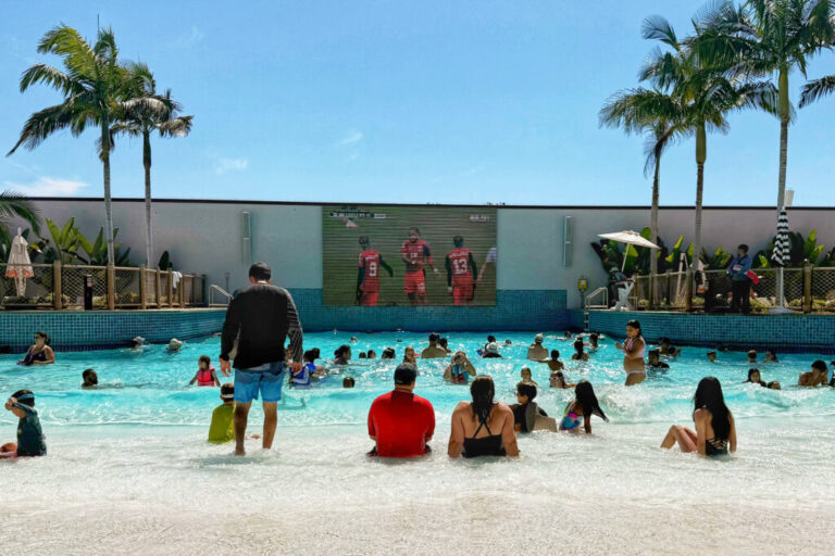 Guests at the Gaylord Pacific Resort and Convention Center wave pool watch Norway play against Senegal on June 22 in Chula Vista, Calif. The resort was filled with young families for Father’s Day, hoping to beat the heat wave, and as soon as the game came on people began to gather around the screen.