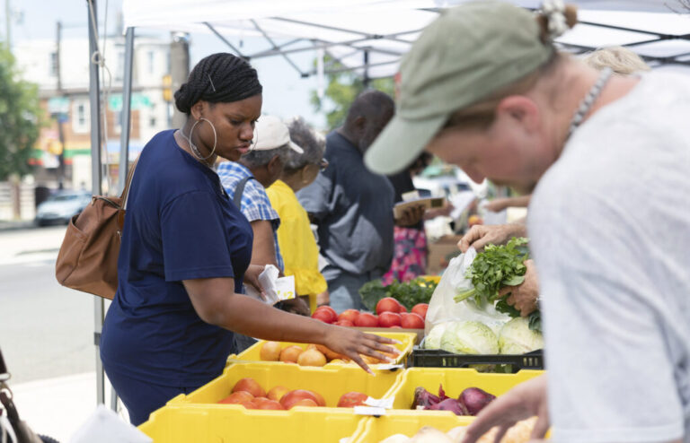 Kate Feurtado, a medical assistant Spectrum Health, browses for produce at a farmers market in Philadelphia, Penn. on July 15, 2026.