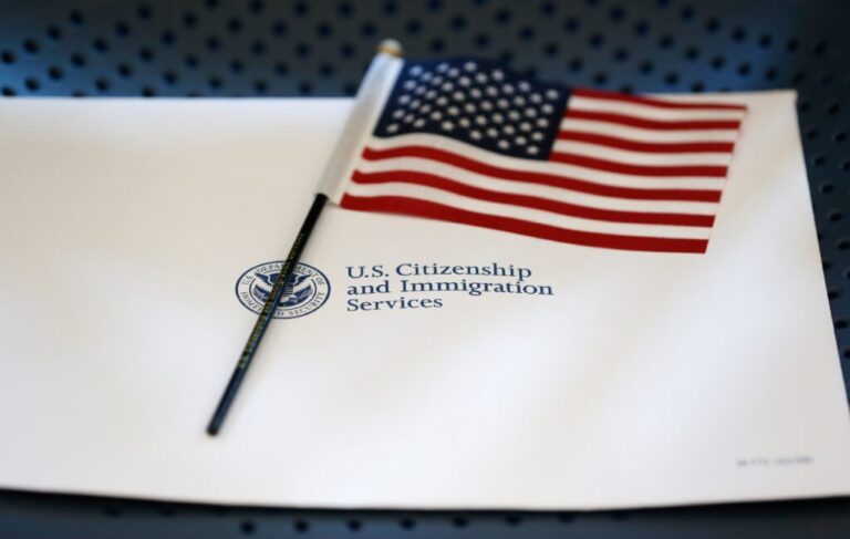 An information packet and an American flag are placed on a chair at the U.S. Citizenship and Immigration Services Miami Field Office on Aug. 17, 2018, in Miami.