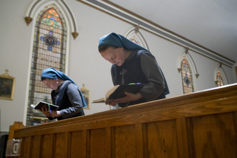 Sister Danielle Lussier and Sister Theresa Alethia sing morning prayers in the chapel next to their home in Mt. Sterling, Ky., in April.