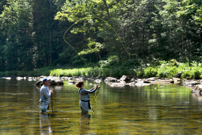 Jim Faust (left) and Noreen Finnegan (right) go fly fishing in the Deerfield River in Charlemont, Mass. on June 27, 2026.