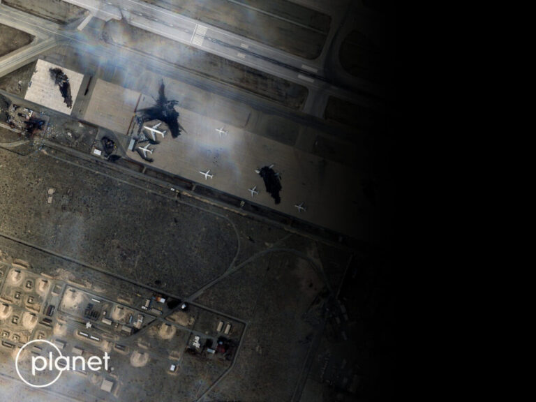 A satellite image of destroyed planes at Mehrabad Airport in Tehran, Iran on March 7 with a fuzzy black screen covering up the right half of the image.