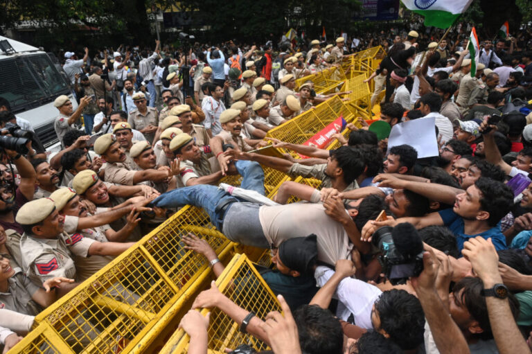 Supporters of the Cockroach Janta Party scuffle with police as they attempt to march toward India's Parliament, demanding the resignation of the education minister, in New Delhi, Monday, July 20, 2026.